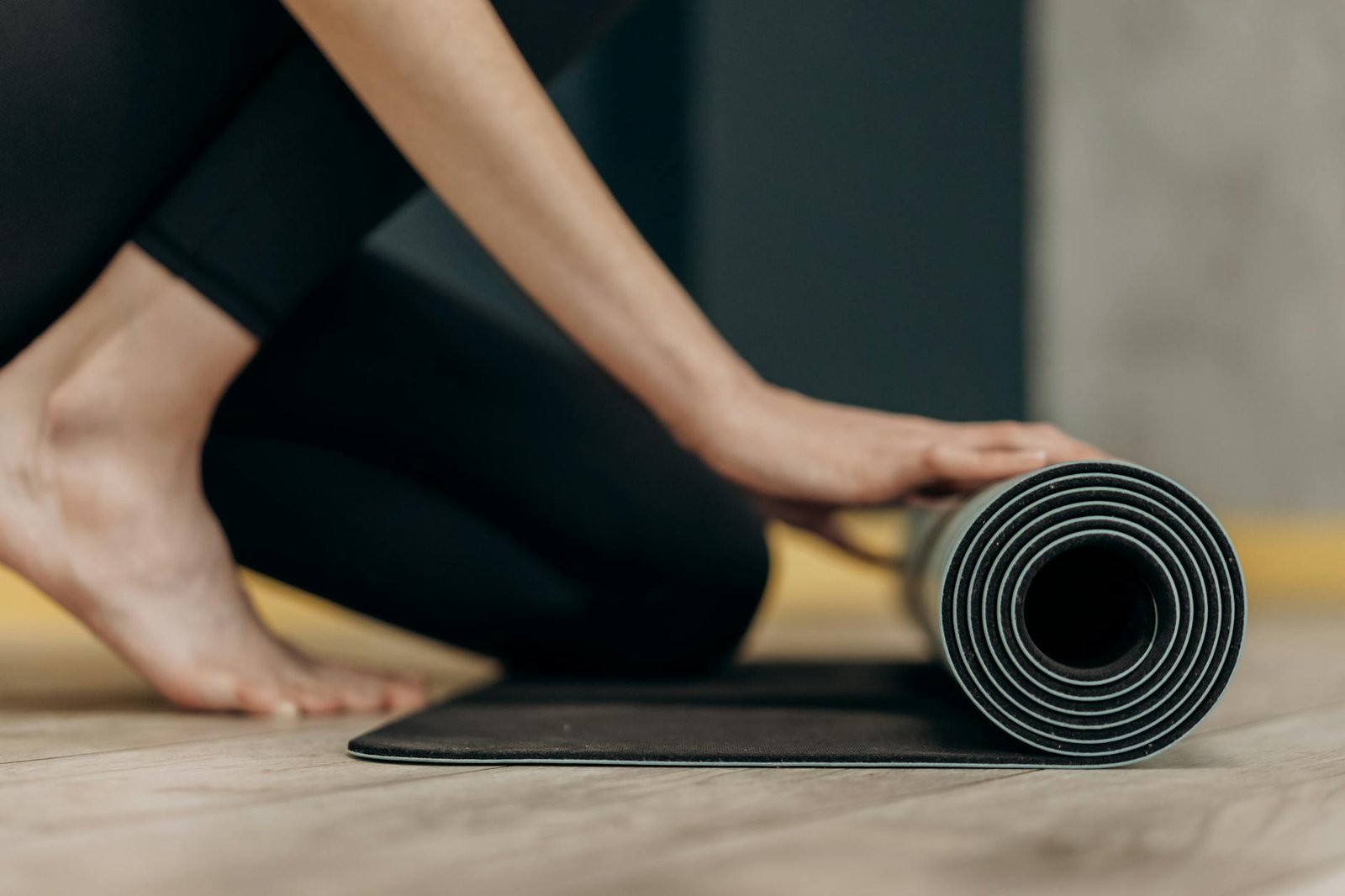 woman rolling a yoga mat